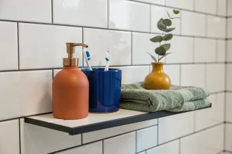 Étagère de salle de bain avec accessoires colorés en céramique terracotta, bleu cobalt et vert sauge